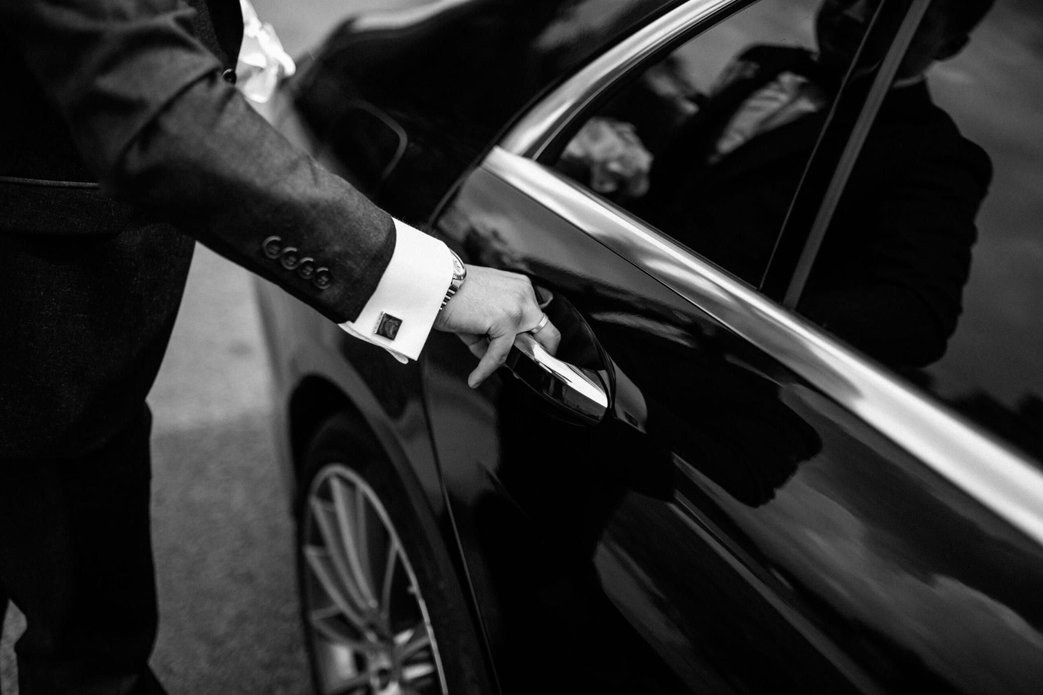 Hand on handle. Close-up of Asian man hand opening / close a car door, chauffeur car service background concept