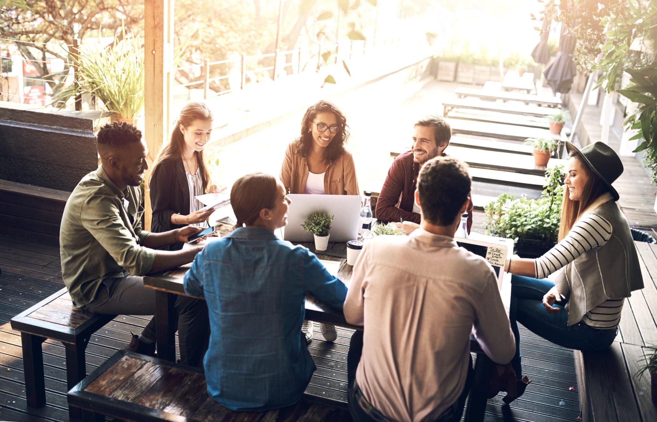 Business, people and creative meeting outside or discussion, planning and website launch with designers. Teamwork, collaboration and developers together, graphic agency and brainstorming conversation.