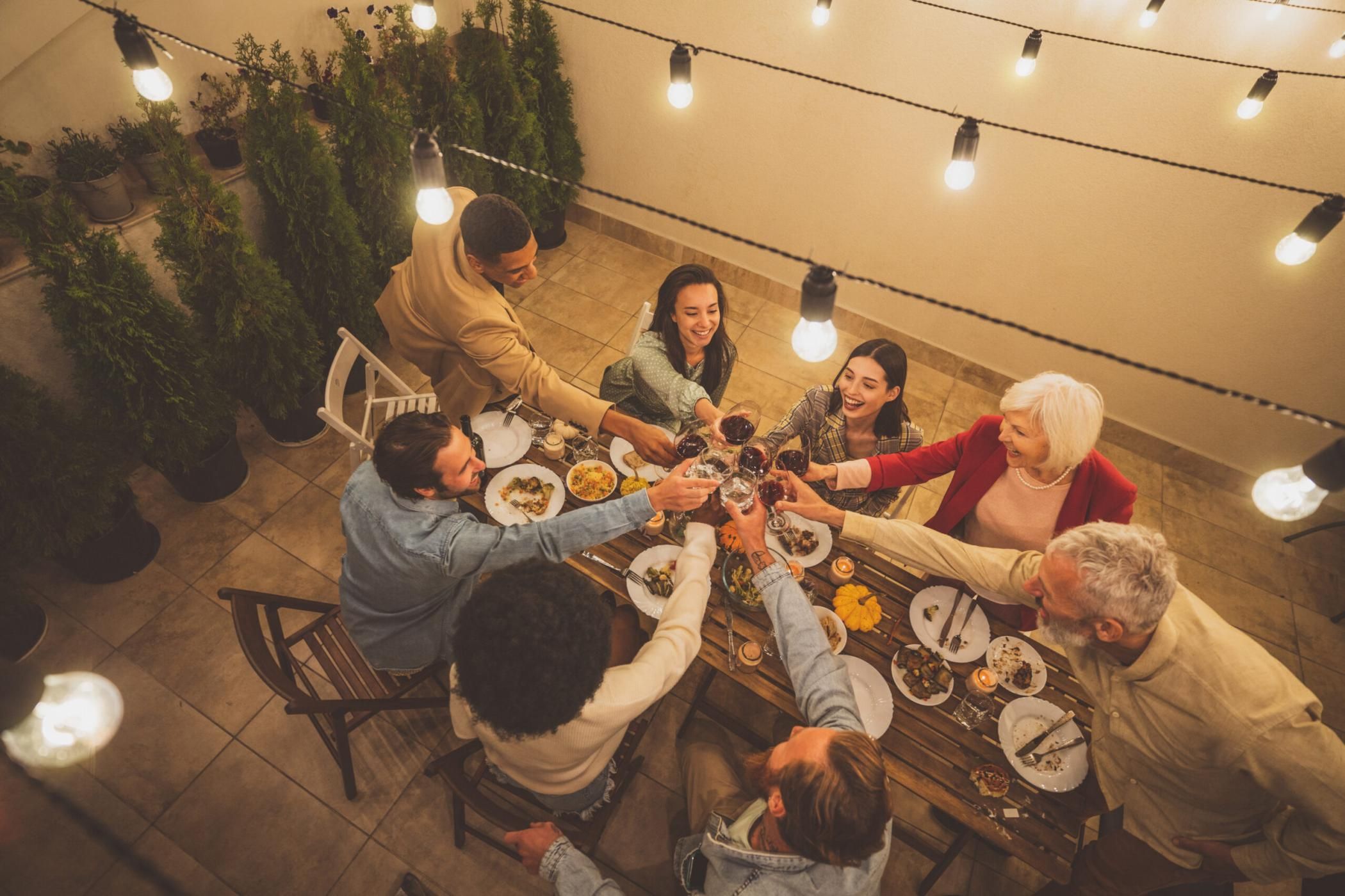 Storytelling footage of a multiethnic group of people dining on a rooftop. Family and friends make a reunion at home