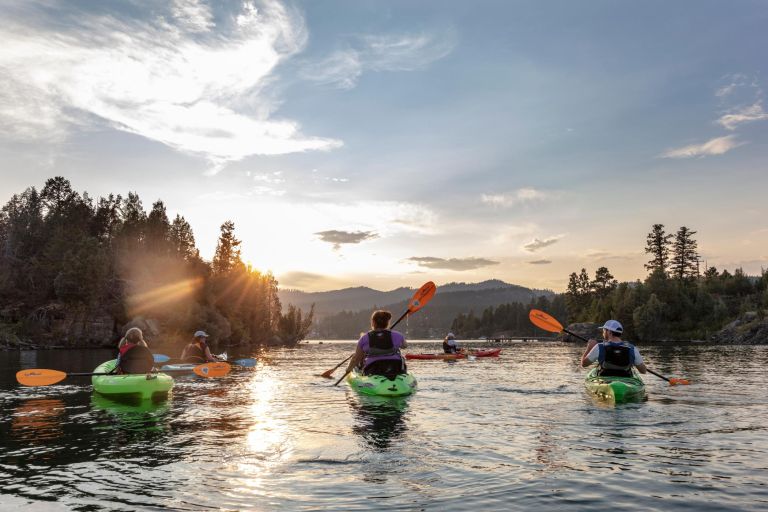 Family sea kayaking on Flathead Lake in Somers, Montana, USA (MR)